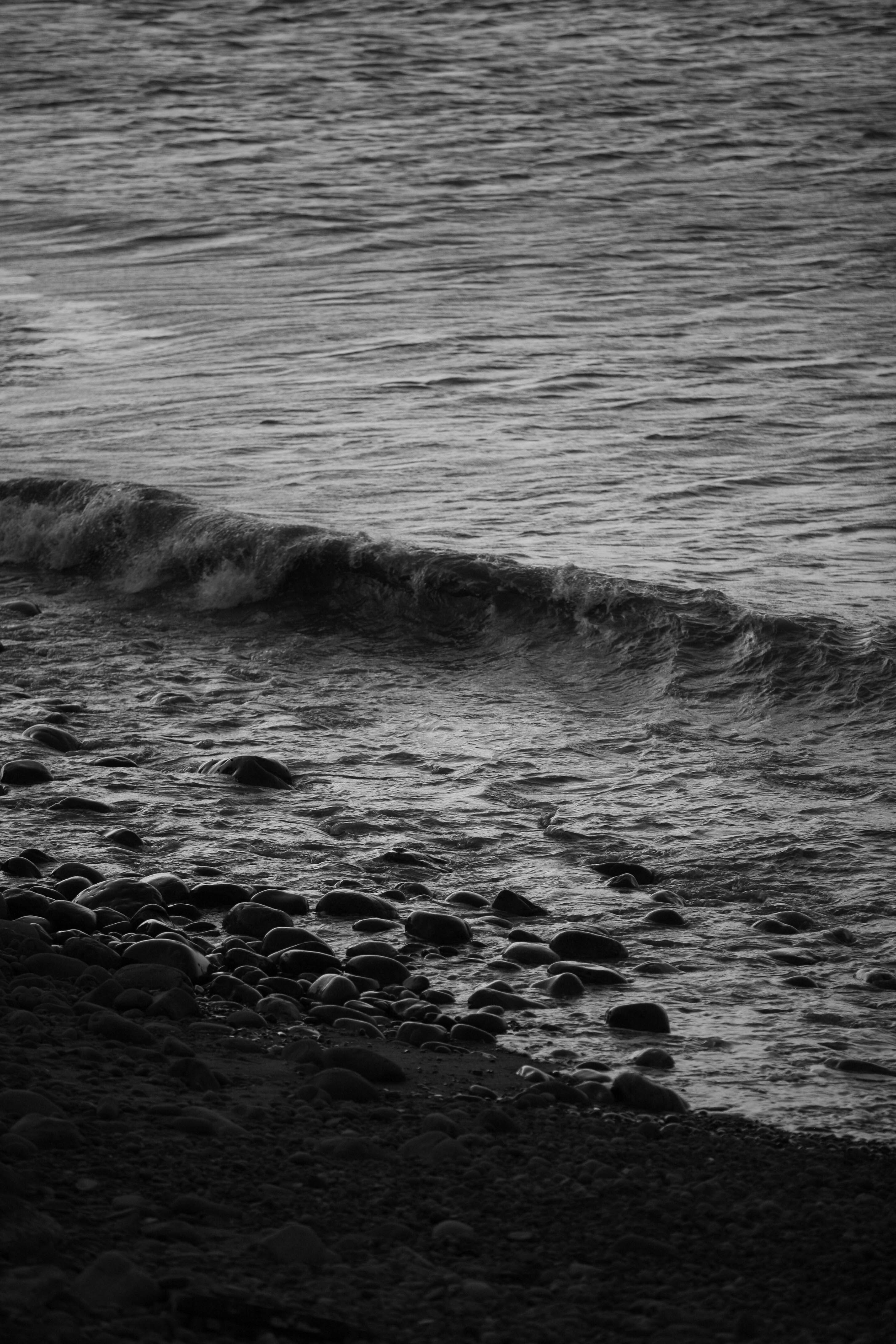 A person walking on a beach with a surfboard
