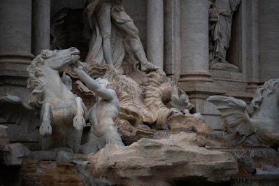 A statue of a man riding a horse in front of a building