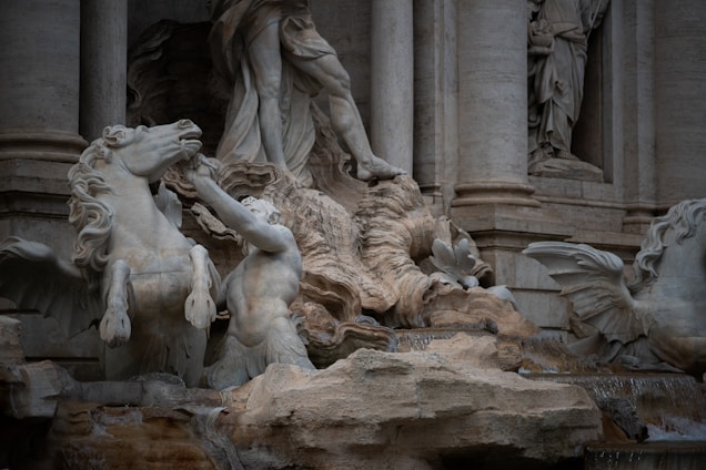 A statue of a man riding a horse in front of a building