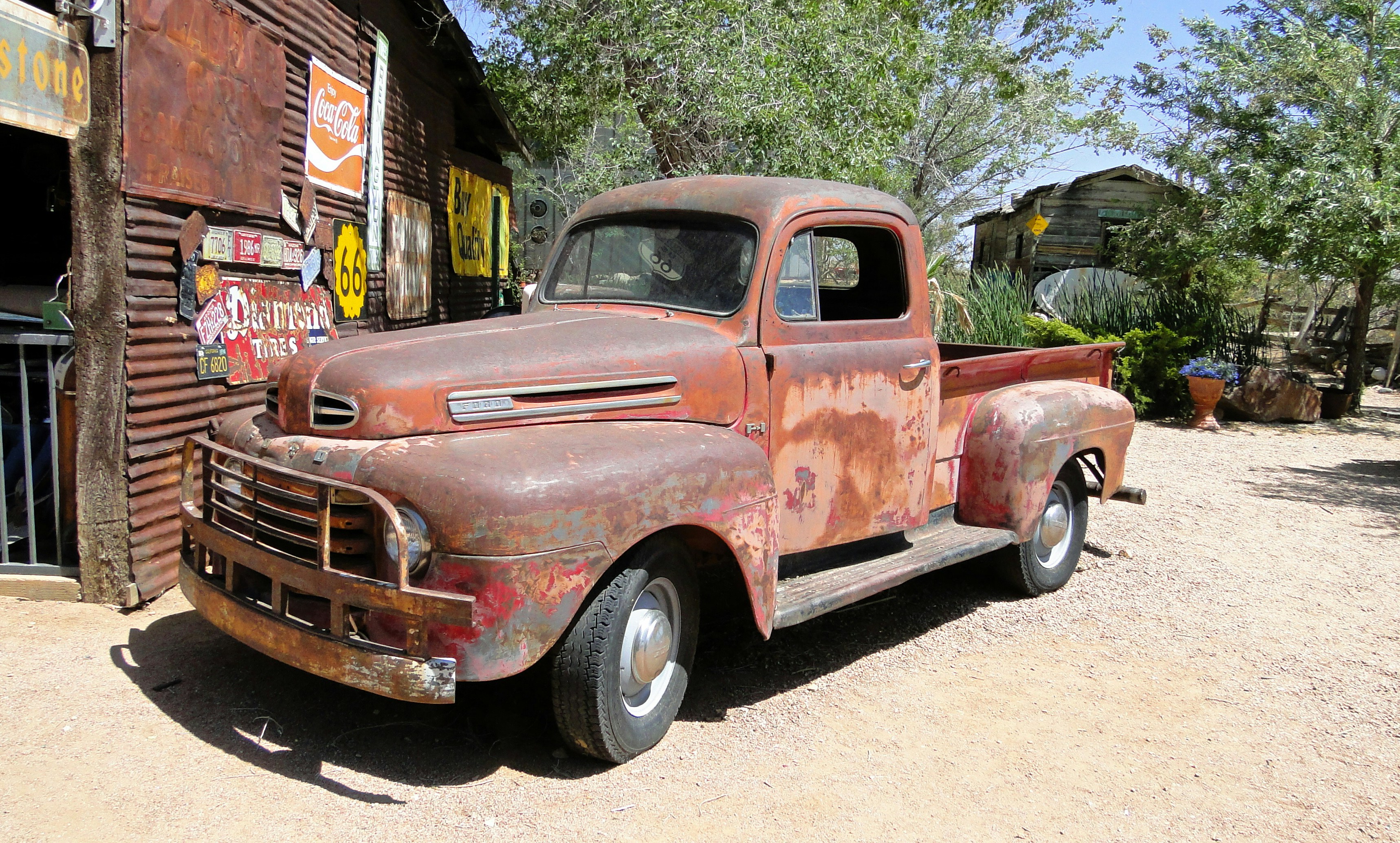 An old rusted truck parked in front of a building