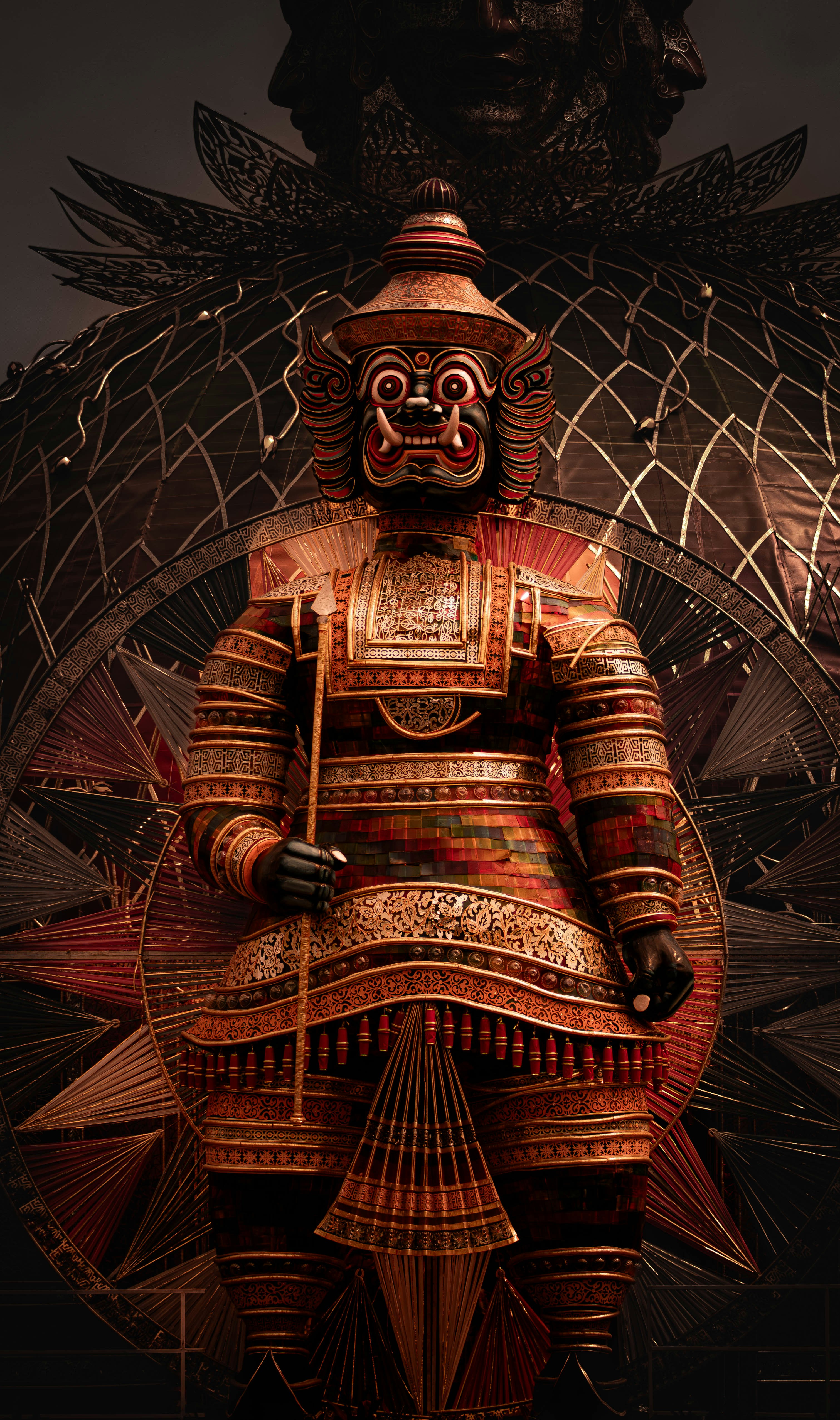 A statue of a person sitting on top of a chair