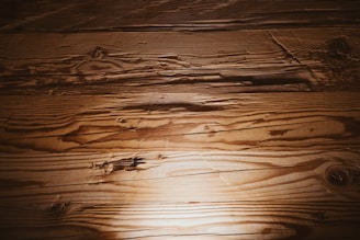 A wooden floor with a light shining on it