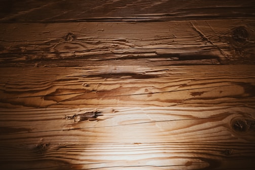 A wooden floor with a light shining on it