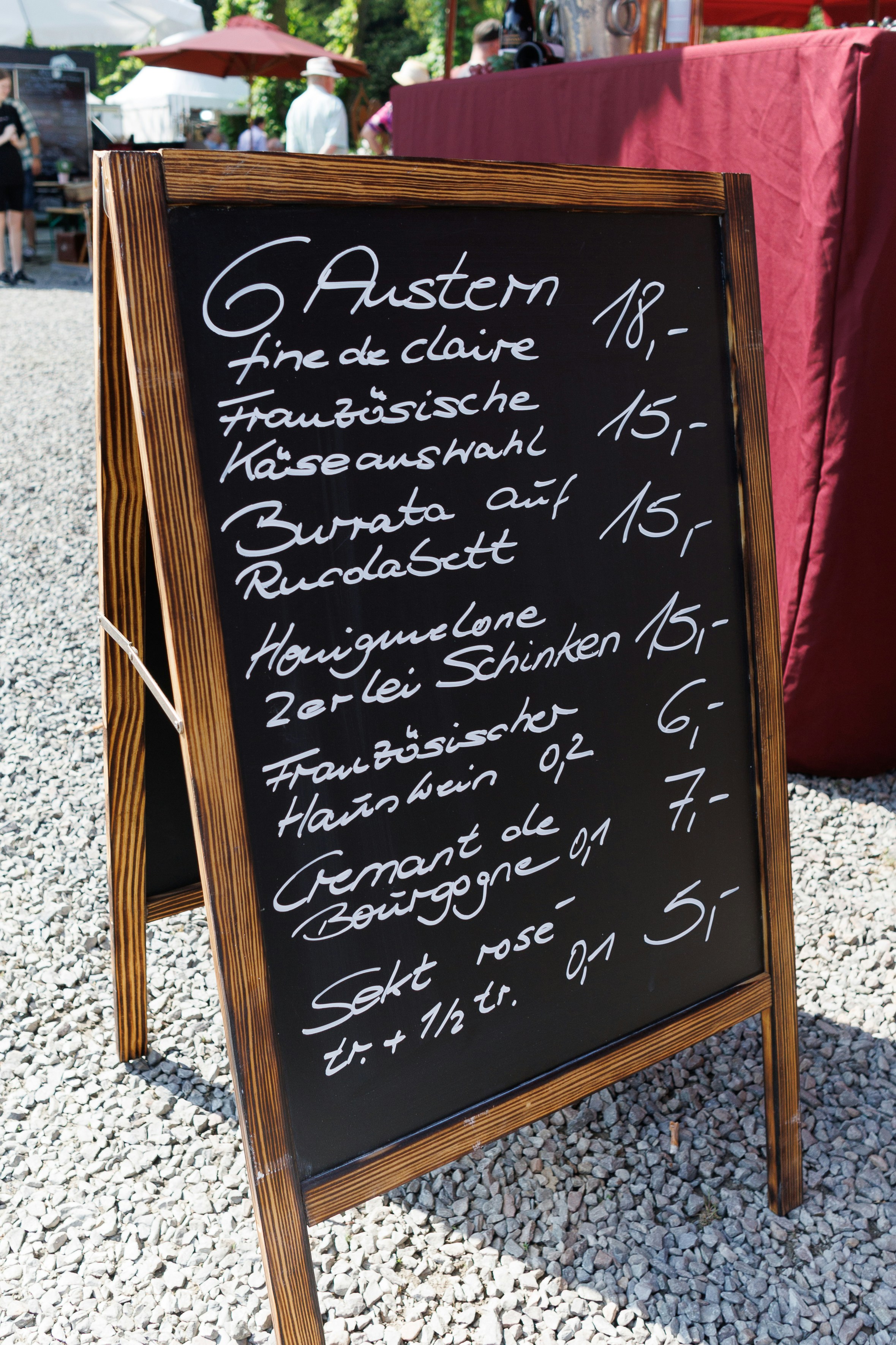 A menu sign sitting on top of a stone floor