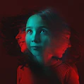 A young girl with her hair blowing in the wind