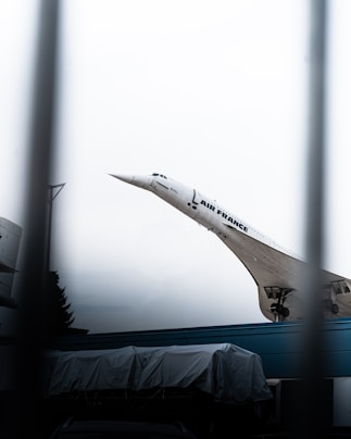 A large jetliner flying through a cloudy sky