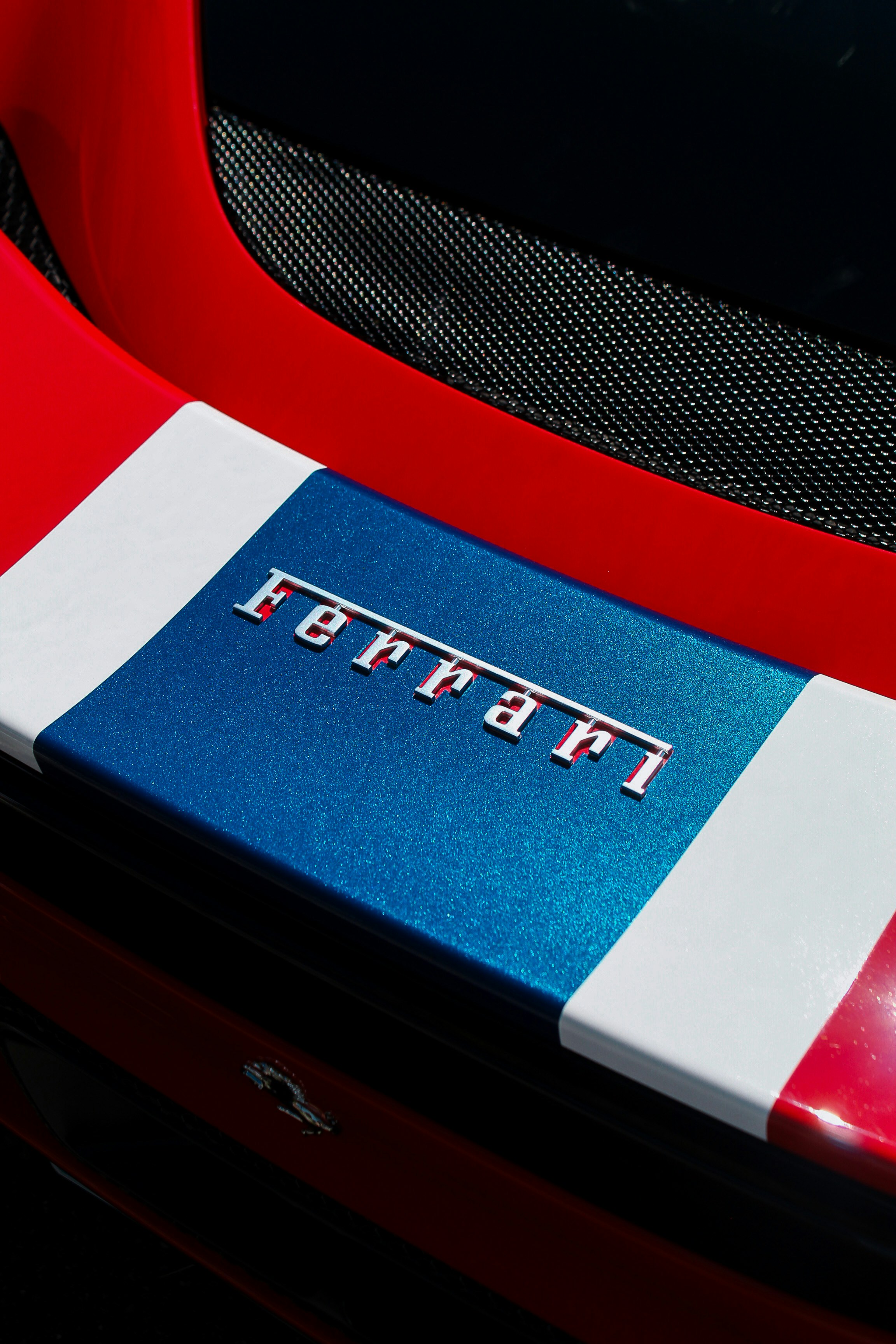 A close up of a red, white and blue car