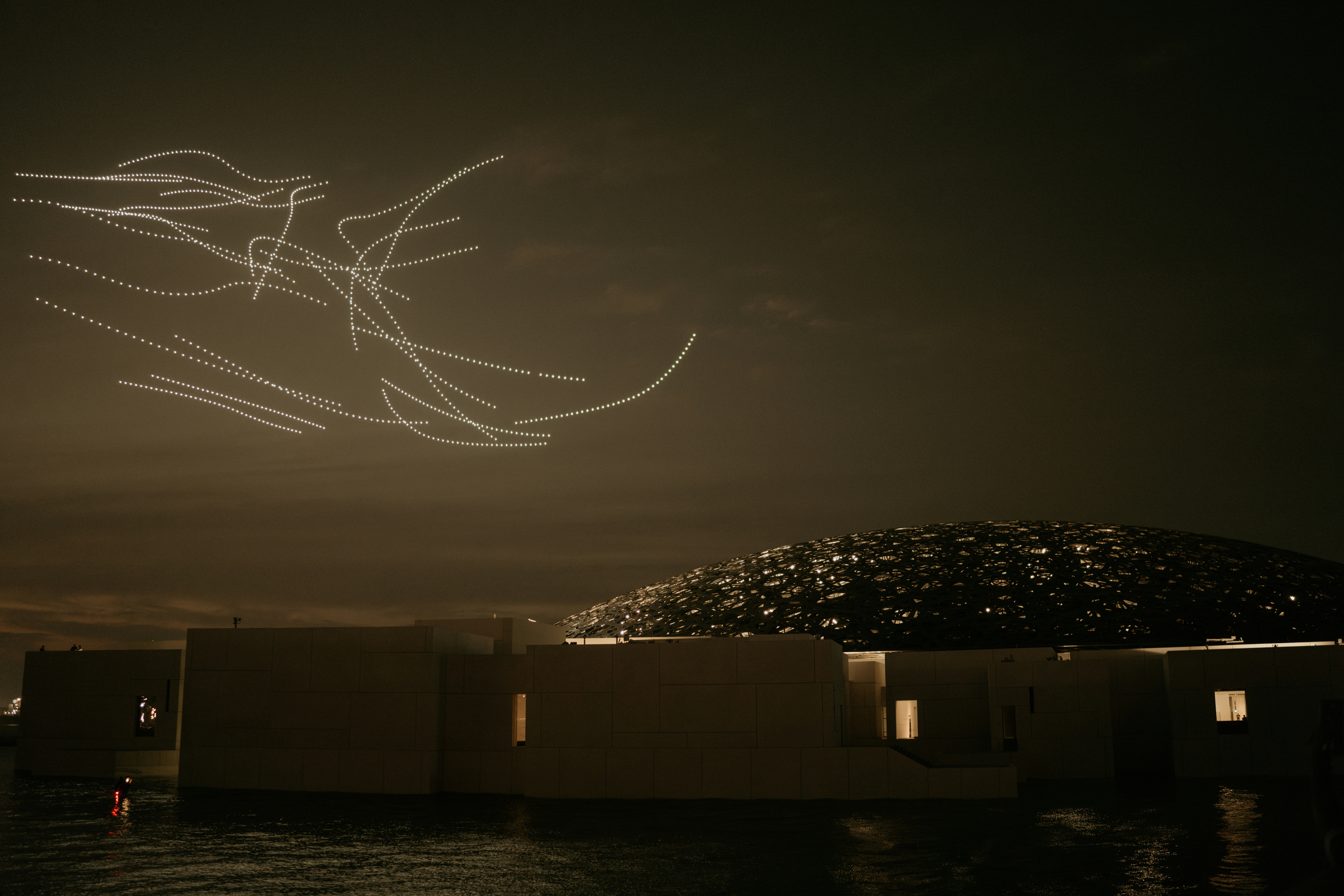 A picture of a plane flying over a building