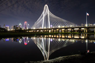 A view of a bridge over a body of water at night