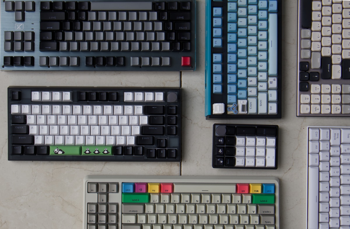 A collection of computer keyboards and mouses on a table