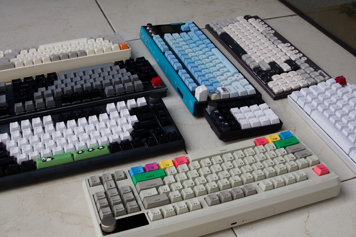 A couple of keyboards sitting on top of a table