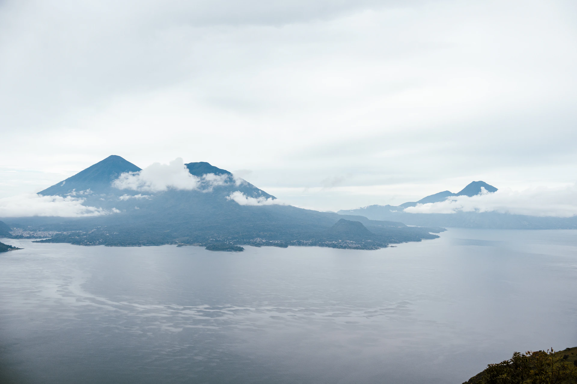 A large body of water with a mountain in the background