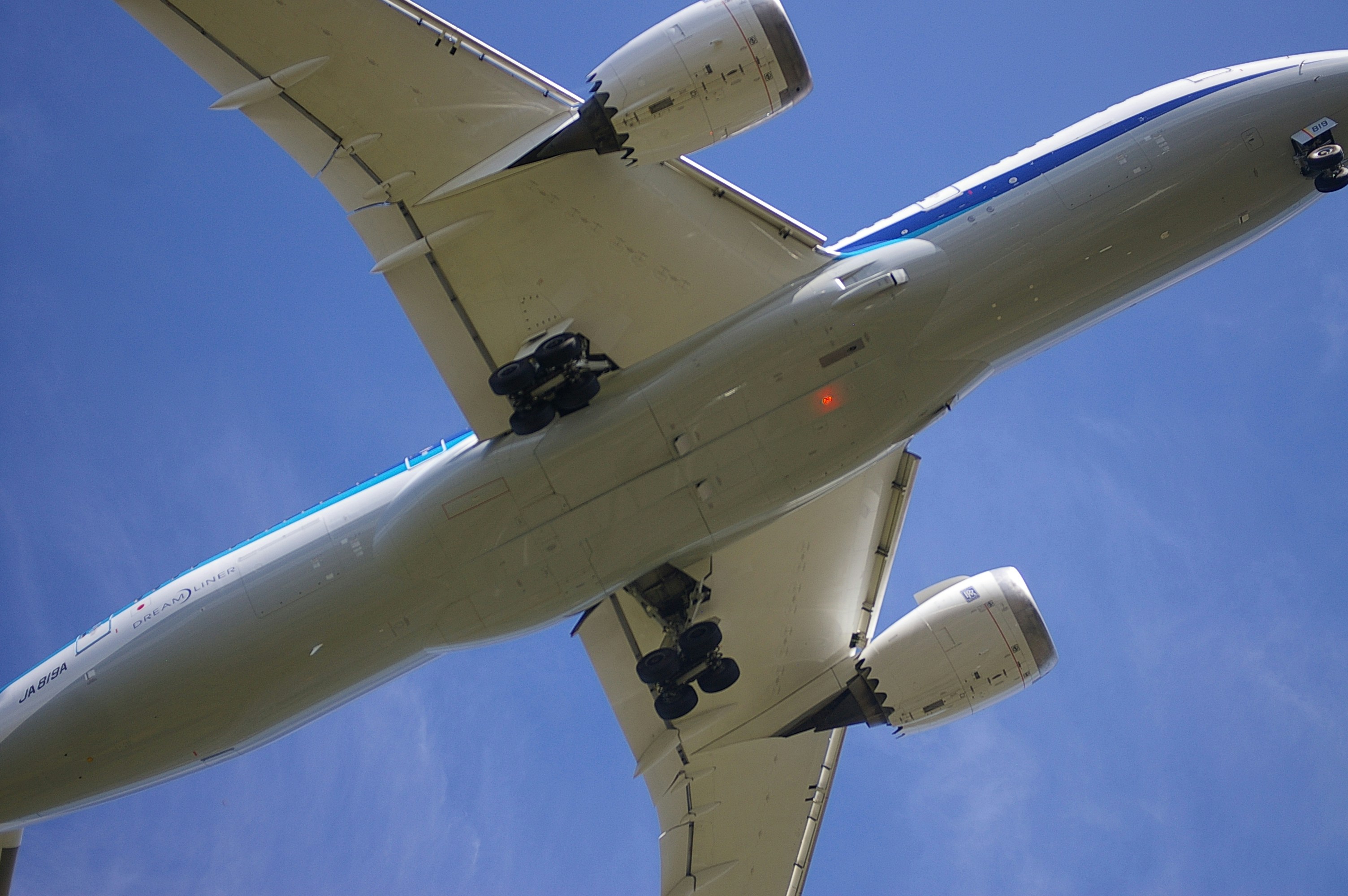 A large jetliner flying through a blue sky
