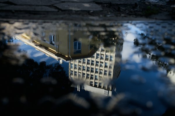 A reflection of a building in a puddle of water — Sofia, Bulgaria