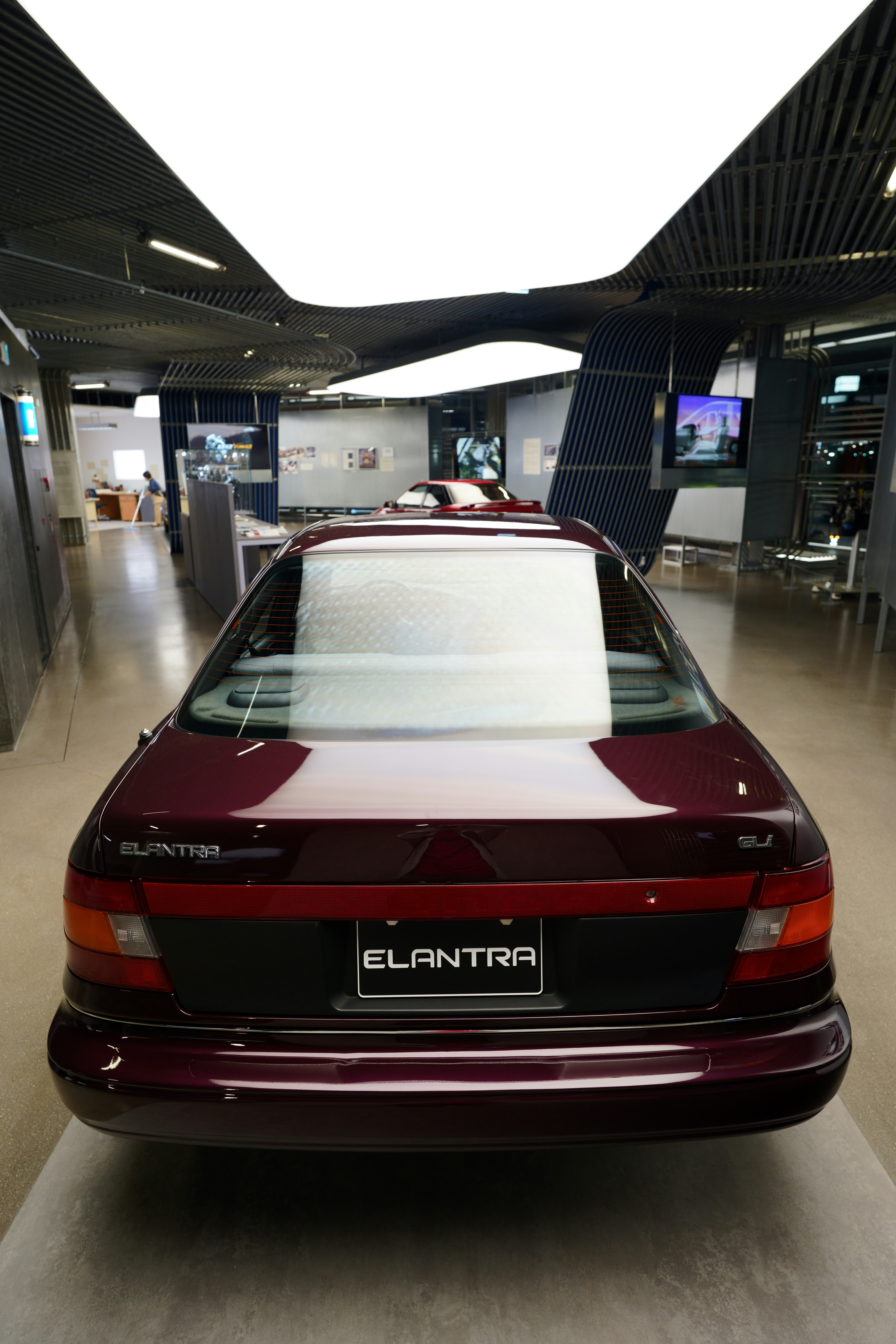 A red car parked in a parking garage