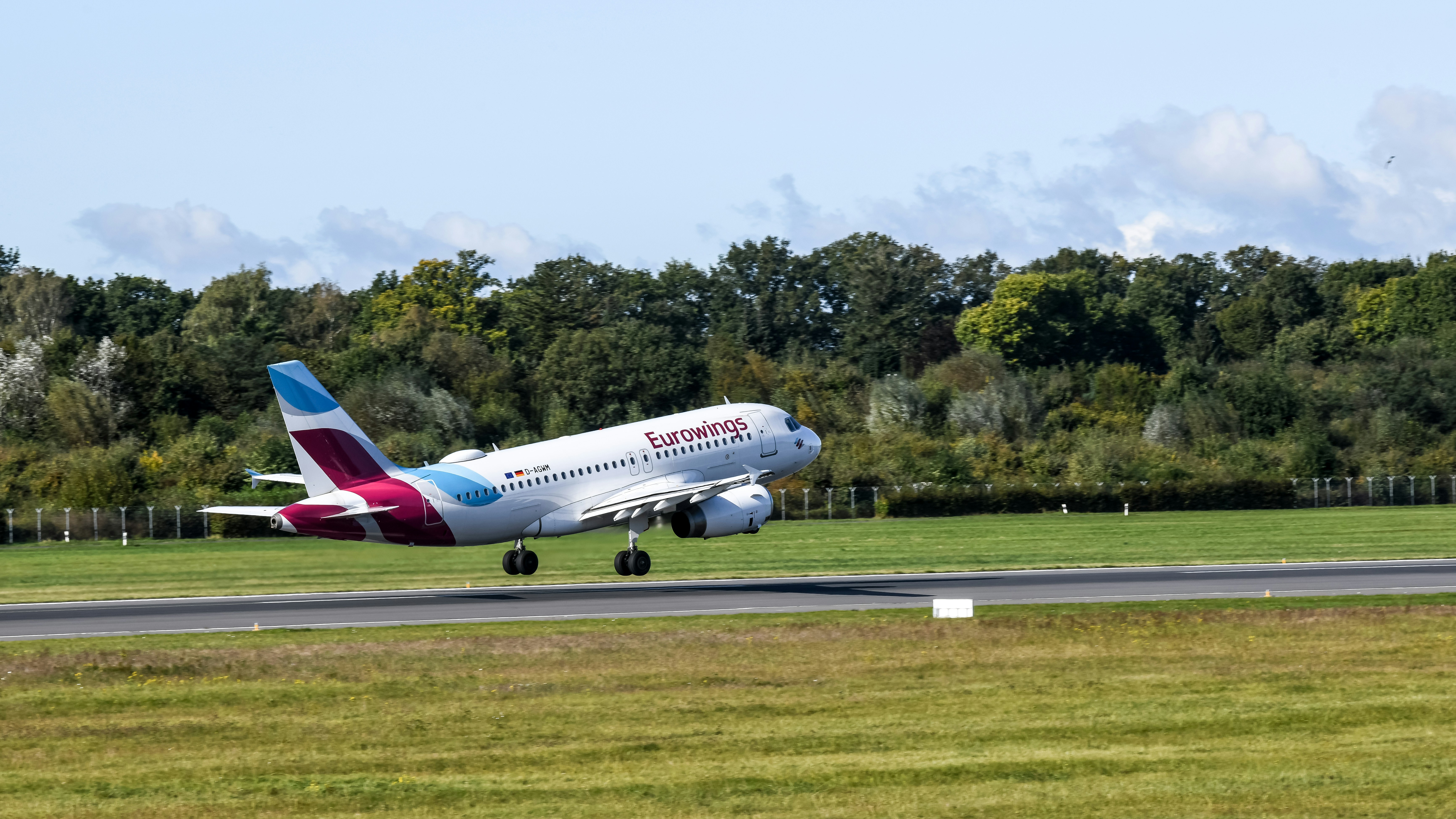 A large jetliner taking off from an airport runway