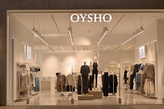 A store front with clothes on display in the window