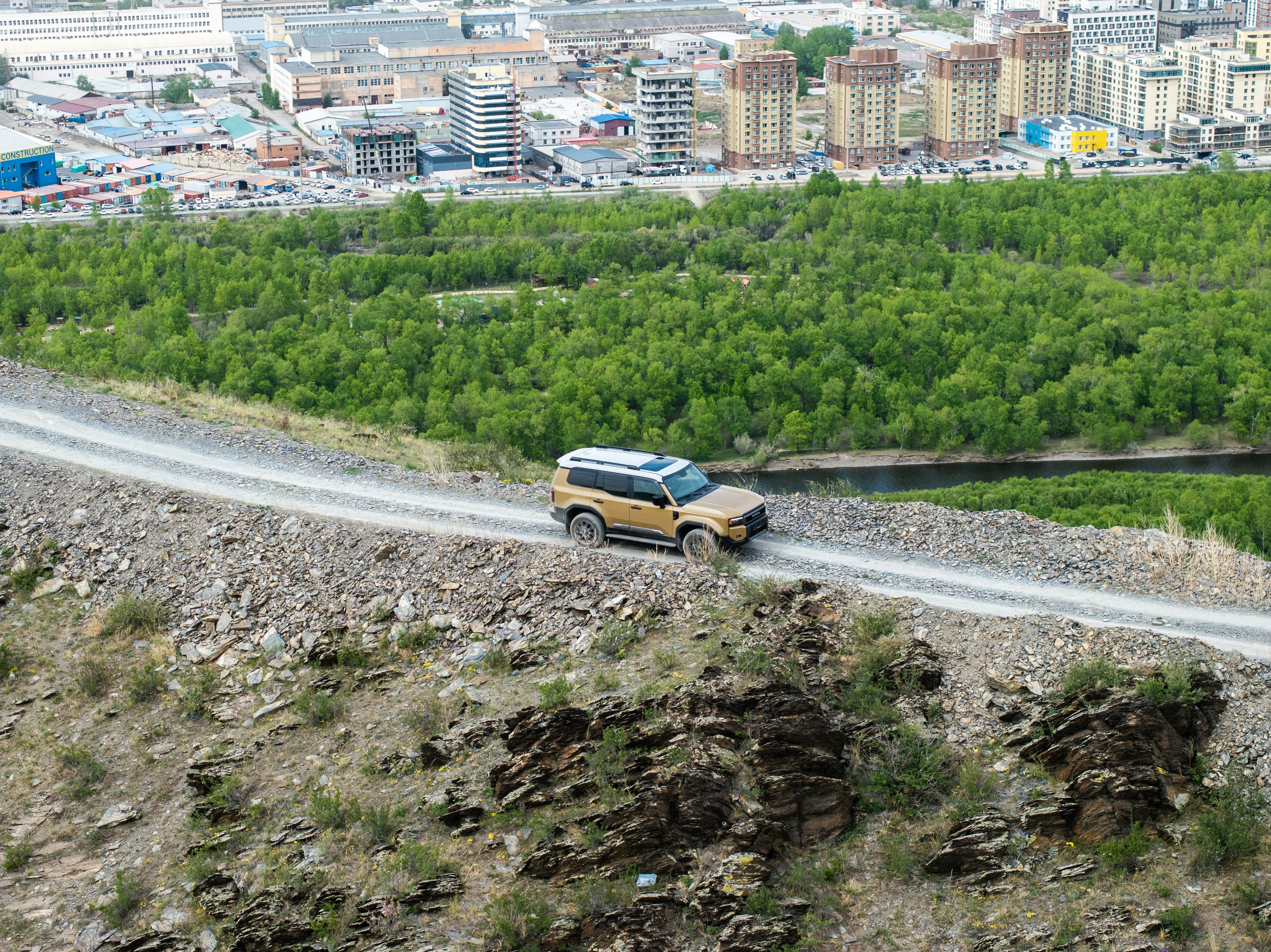 A car is driving down a winding road