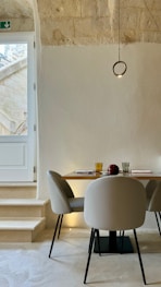 A dining room with a table and chairs