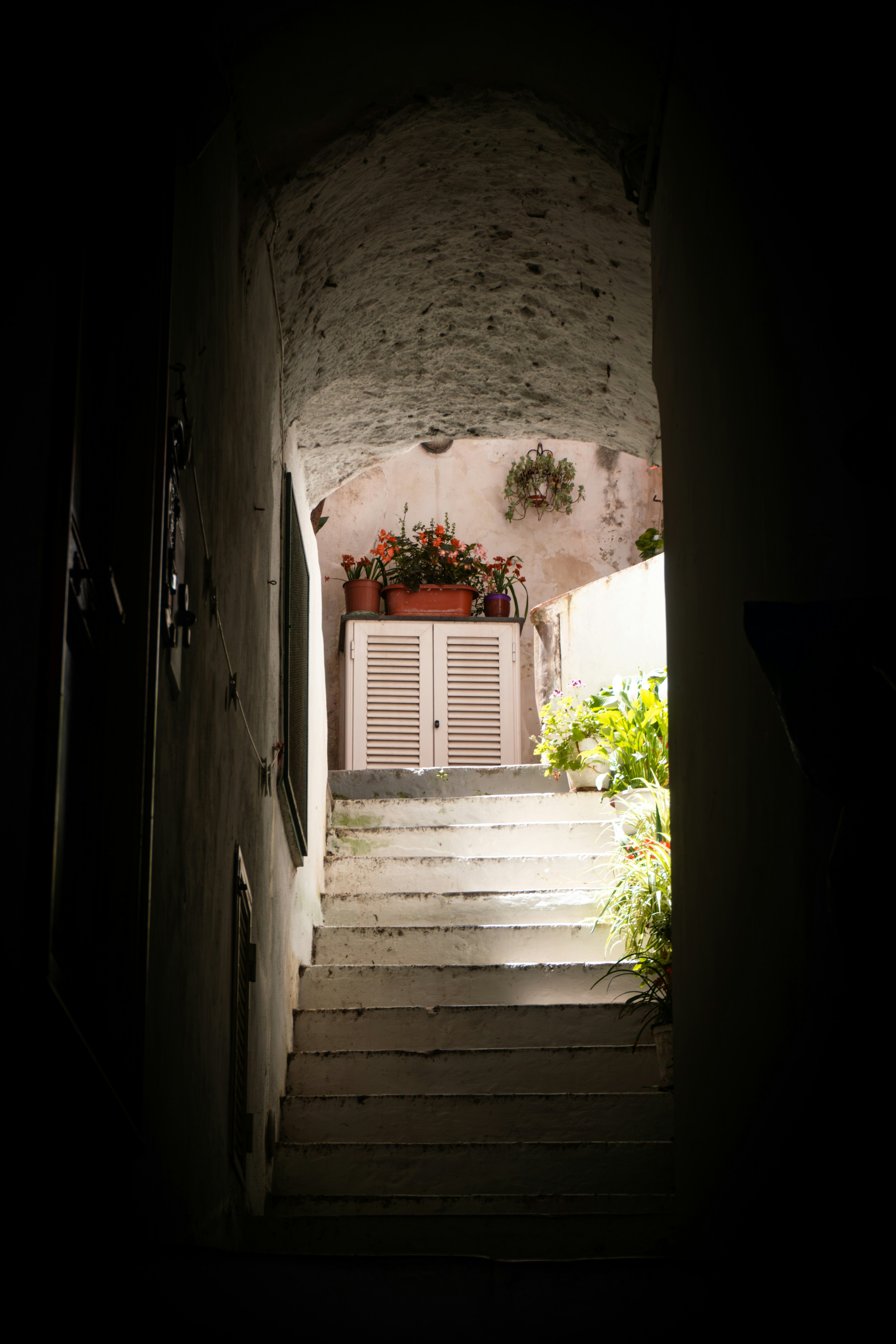 A dark hallway with a door leading to a balcony