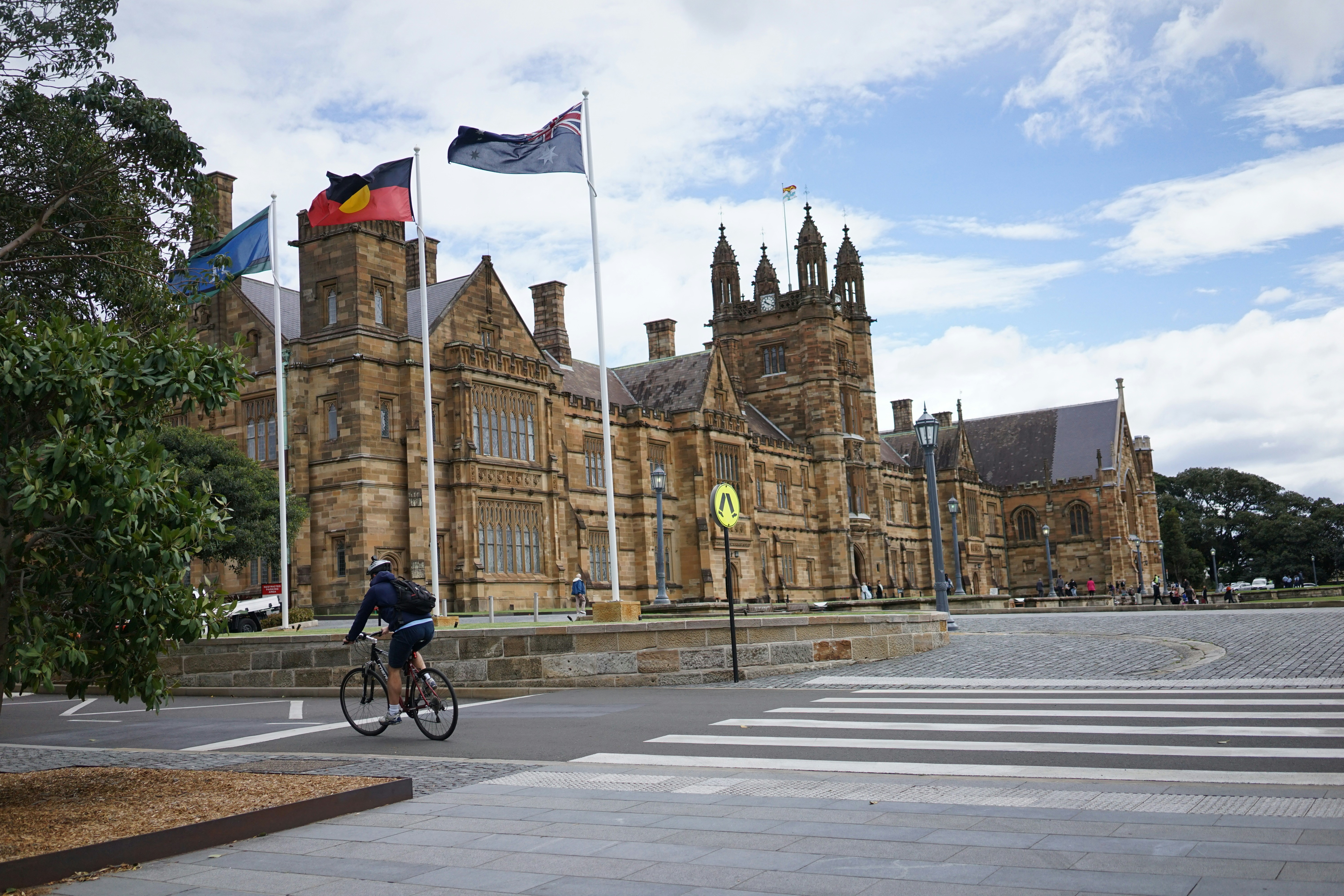 A person riding a bike in front of a building