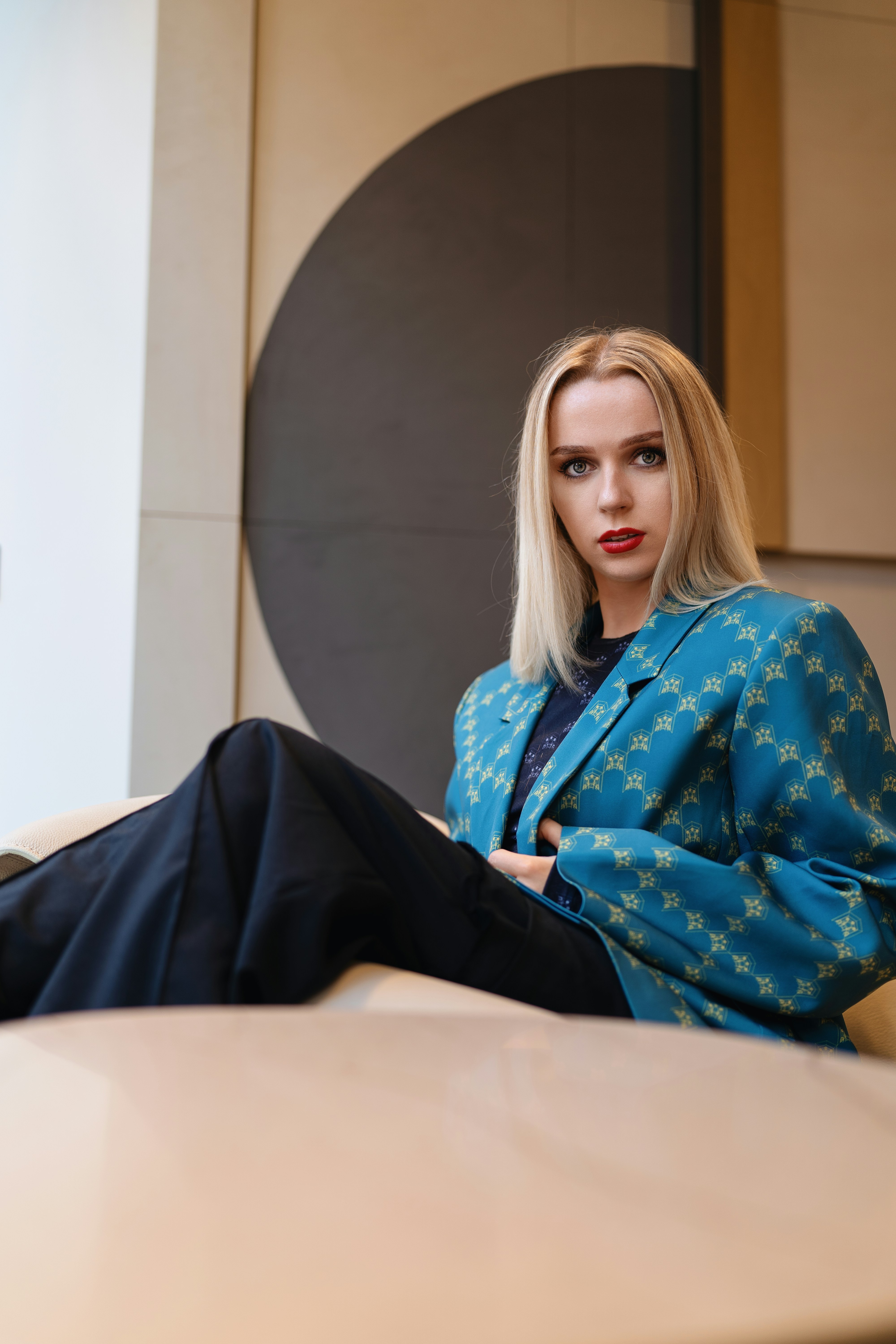 A woman sitting on a table with her legs crossed