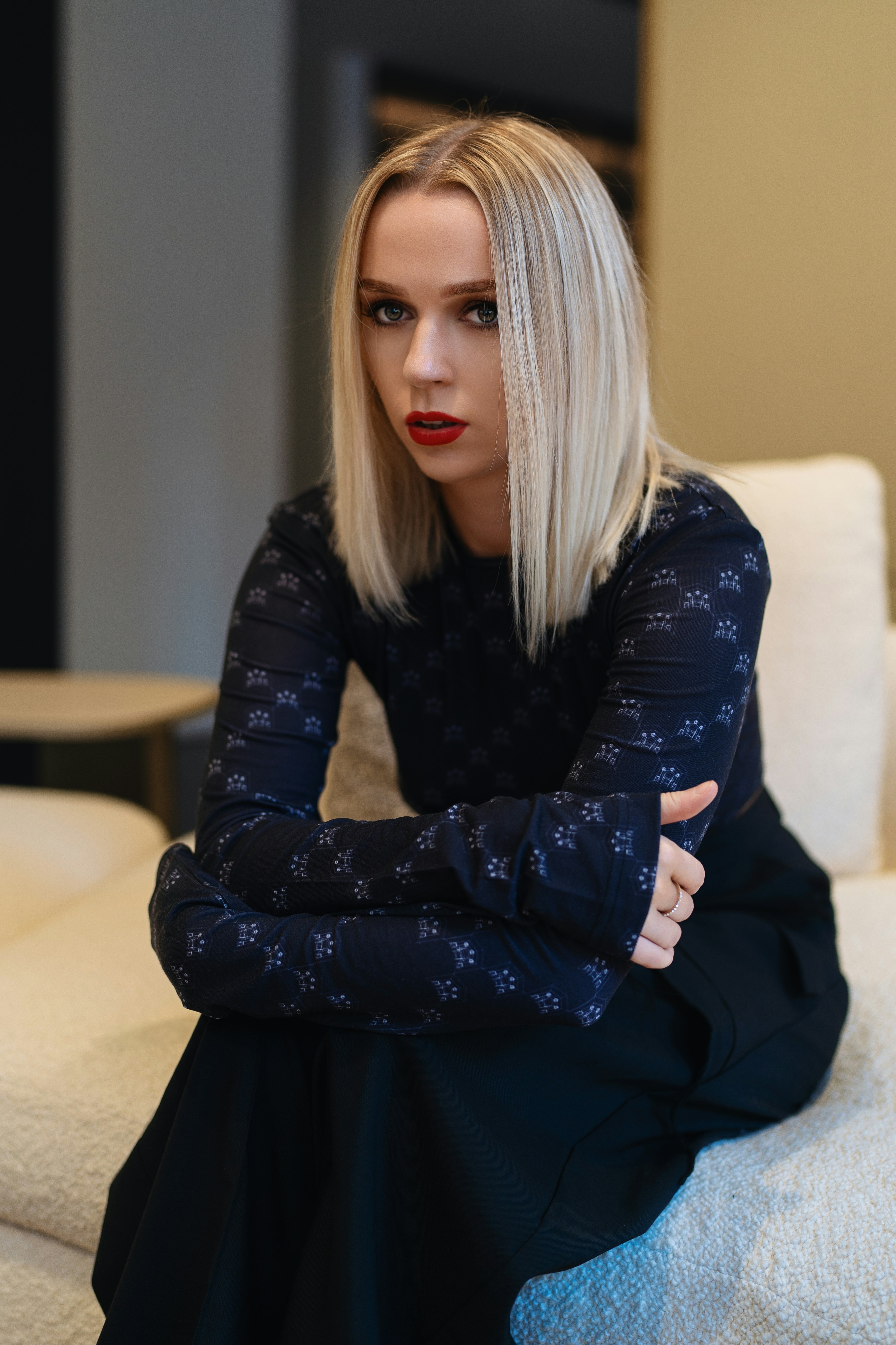 A woman sitting on top of a white couch