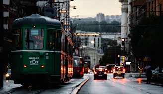 A city street filled with lots of traffic next to tall buildings