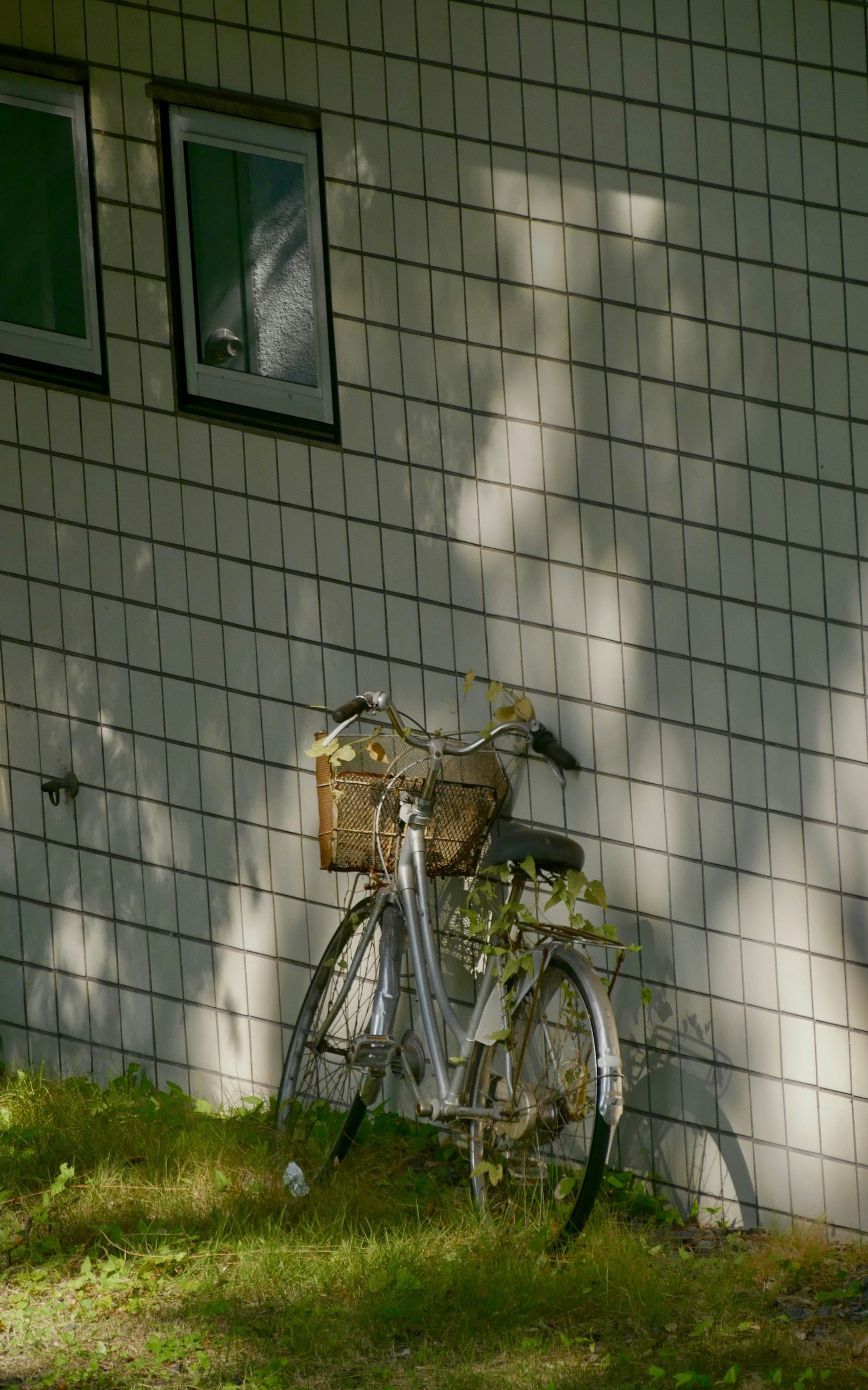 A bike parked next to a white building