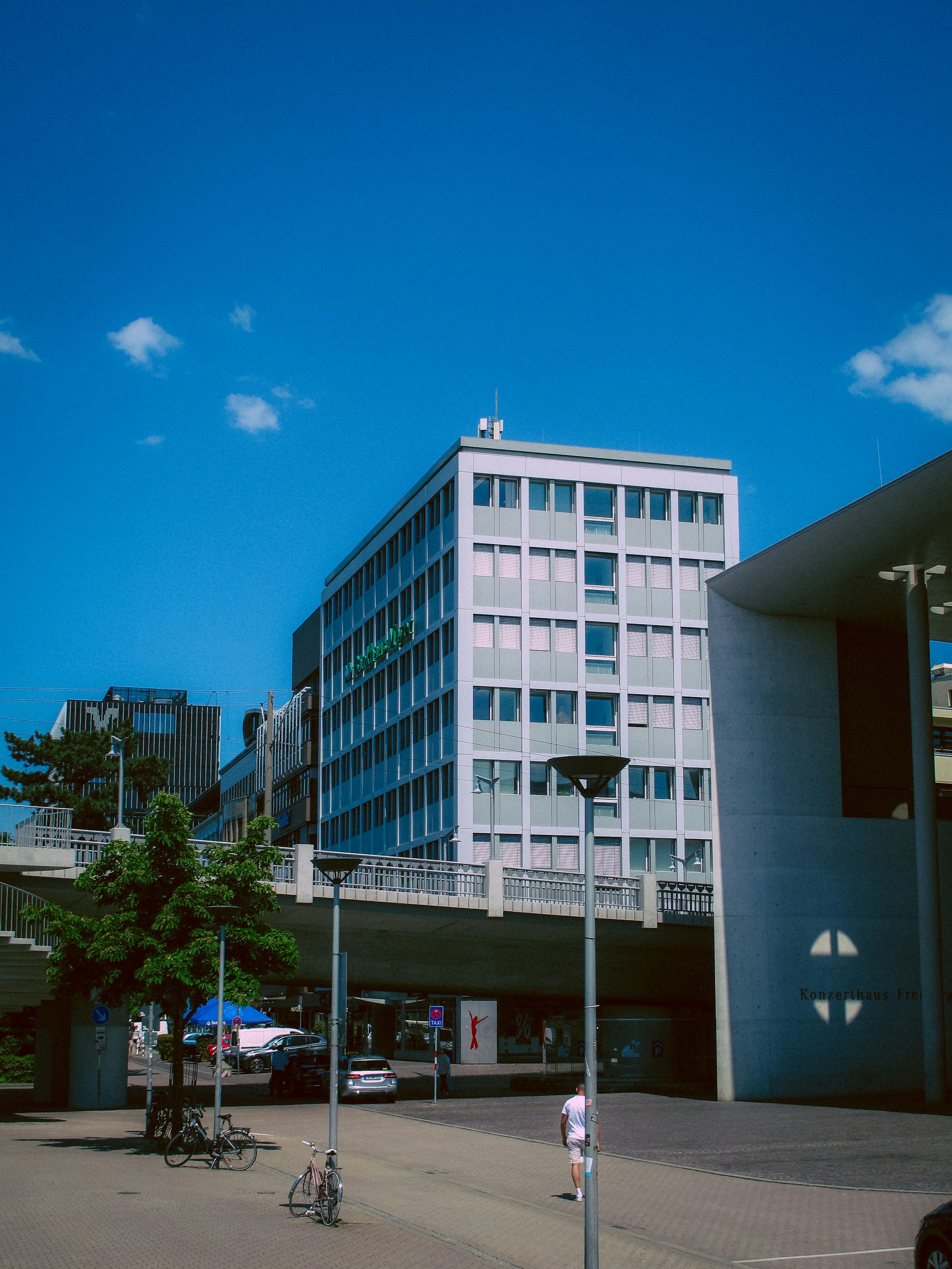 A large building sitting next to a tall building