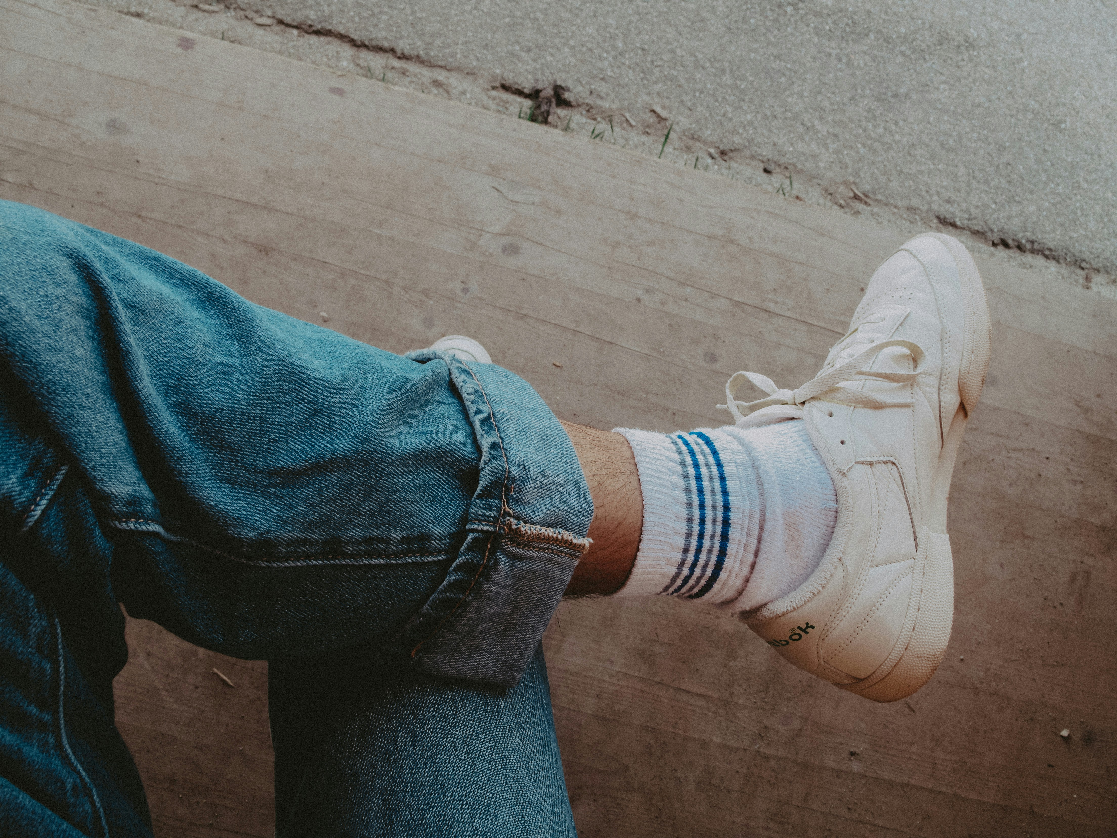A person with their feet up against a wall