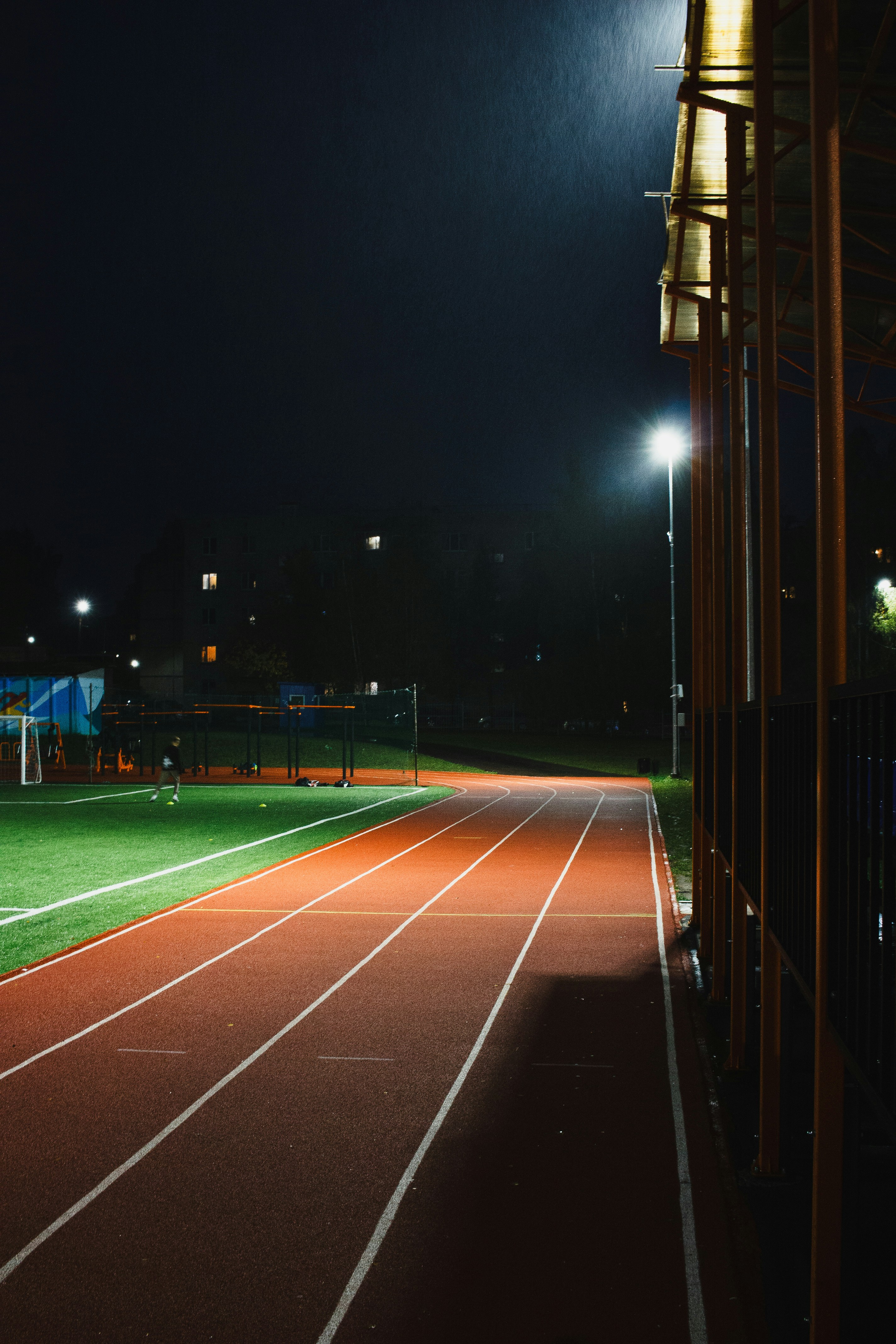 A night shot of a running track at a stadium