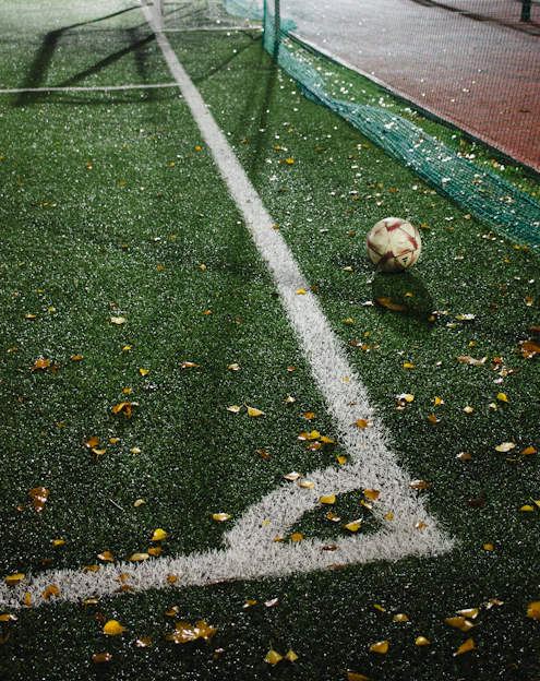 A soccer ball sitting on top of a soccer field