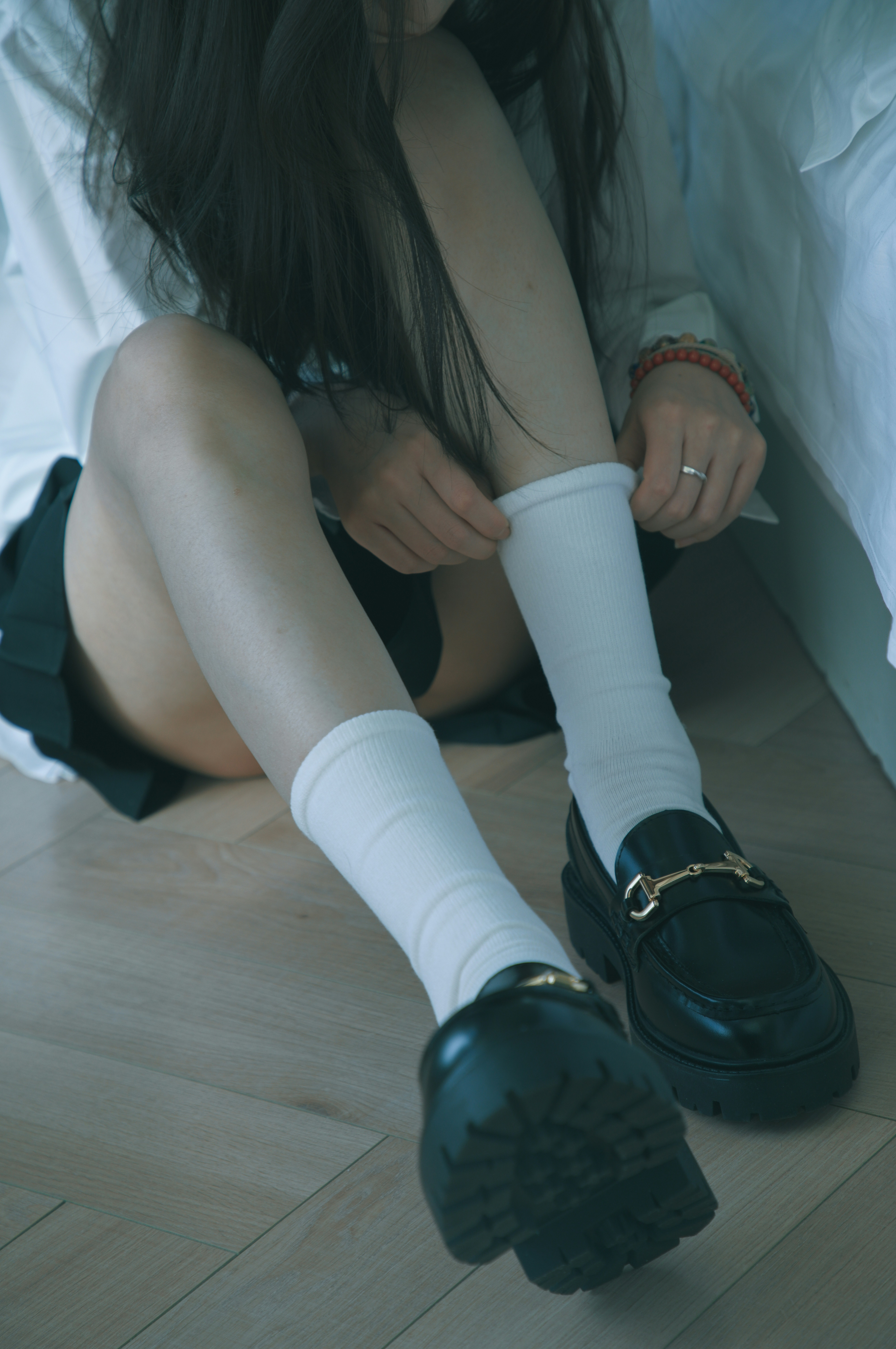 A woman sitting on the floor with her legs crossed