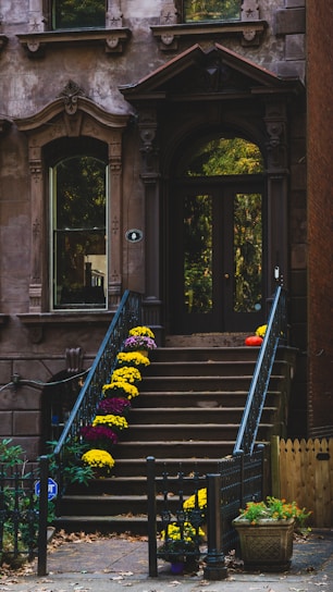 A building with a bunch of flowers on the steps