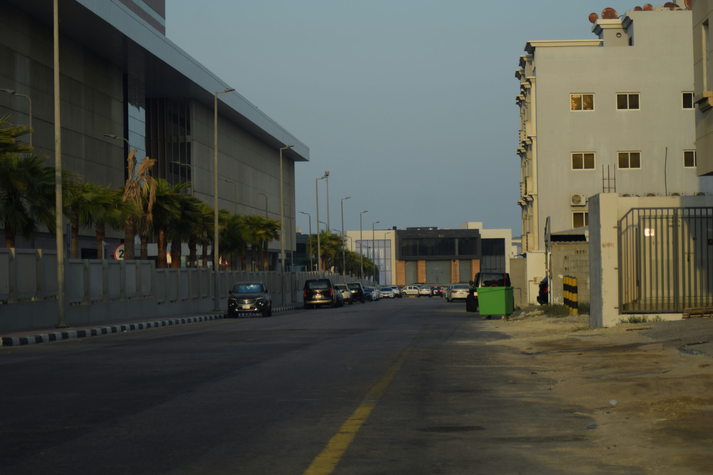 A street with cars parked on the side of it