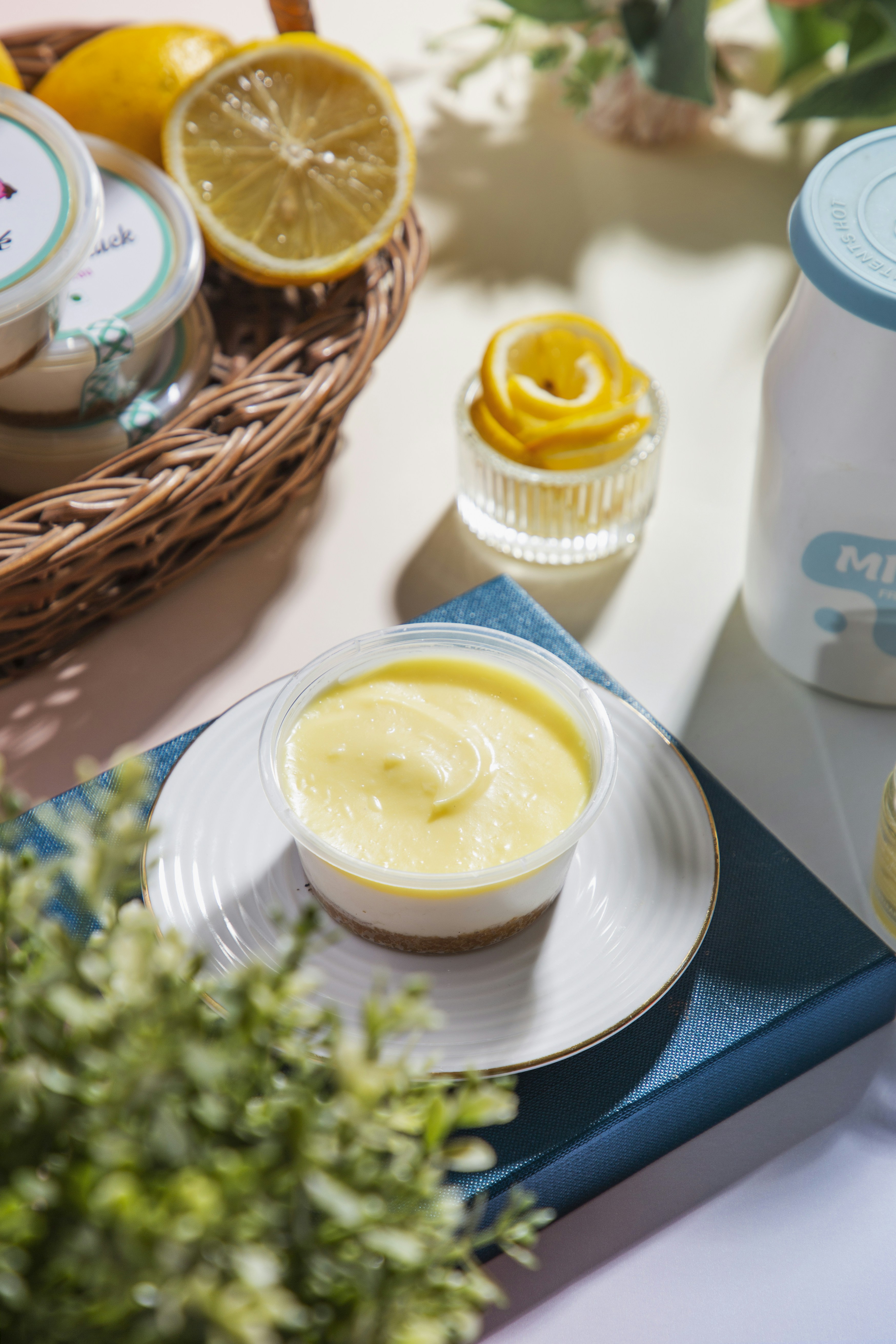 A bowl of yogurt next to a bottle of yogurt and a