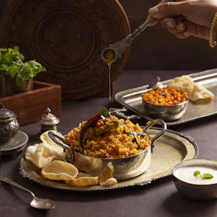 A person holding a spoon over a bowl of food