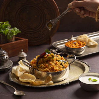 A person holding a spoon over a bowl of food