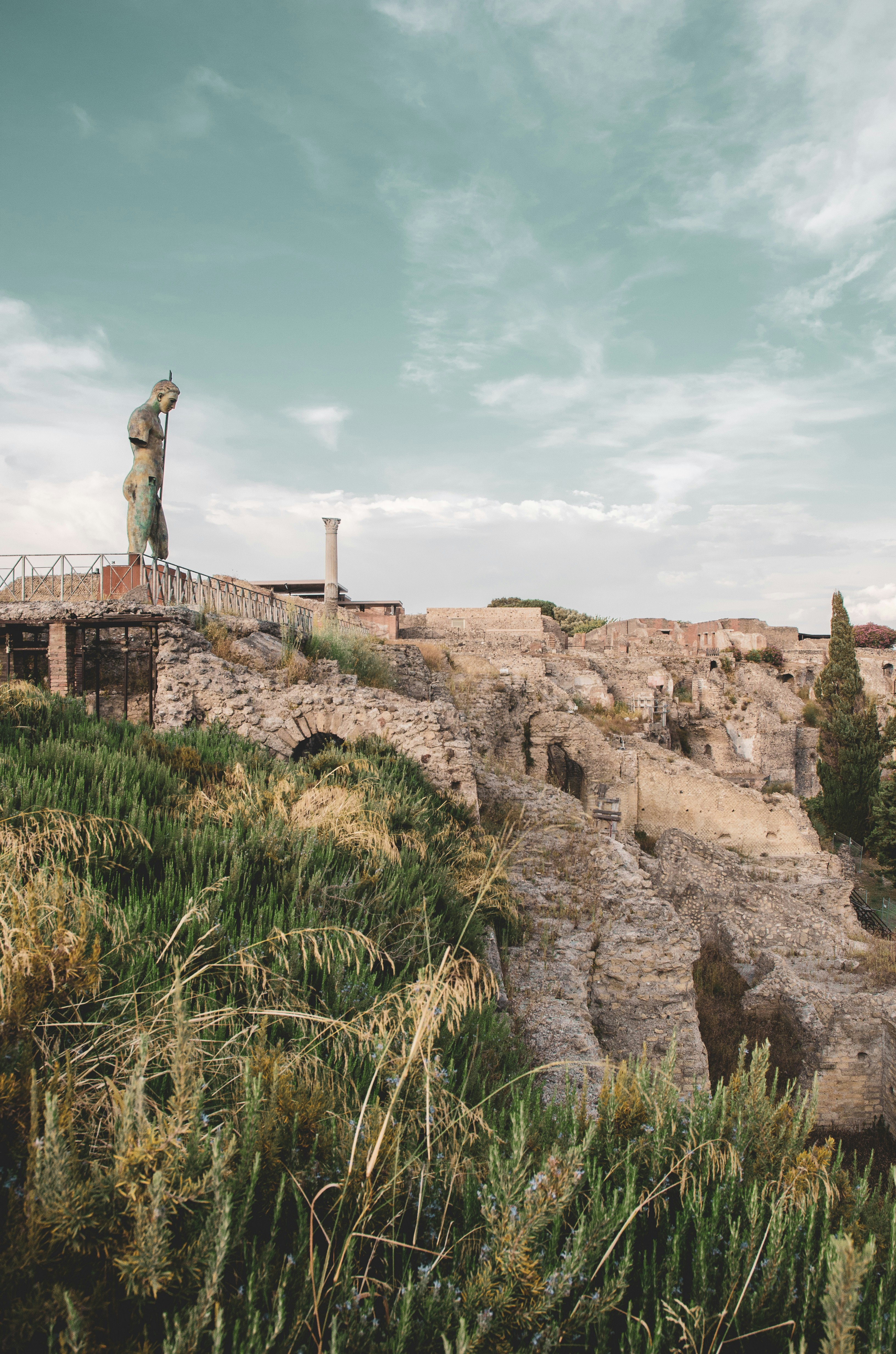 A statue on top of a hill with a sky background
