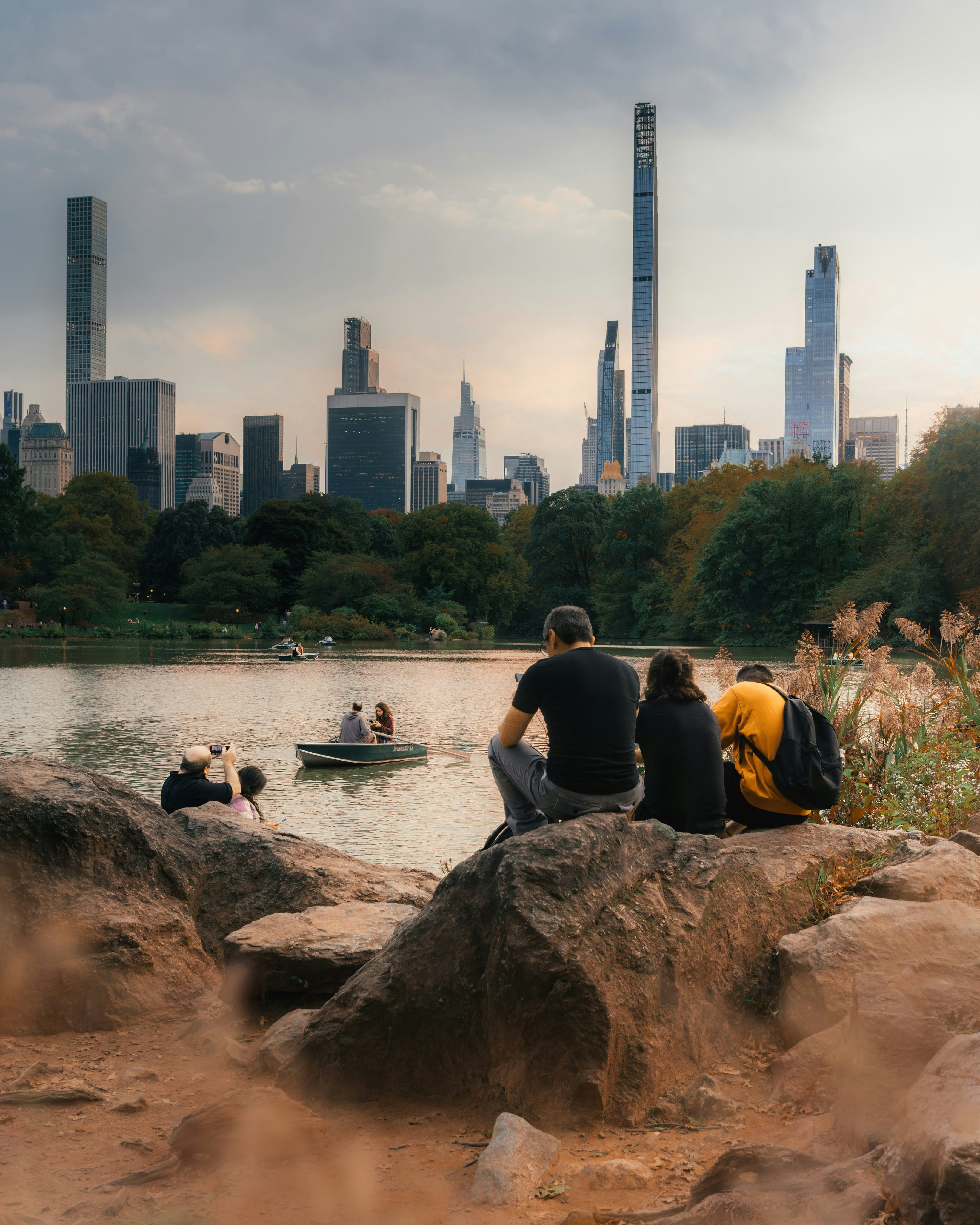 A couple of people that are sitting on some rocks