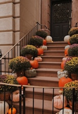 A bunch of pumpkins sitting on the steps of a building