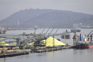 A large boat docked at a dock with a mountain in the background