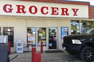 A truck parked in front of a grocery store