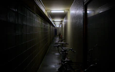 A long hallway with bikes parked on the side of it
