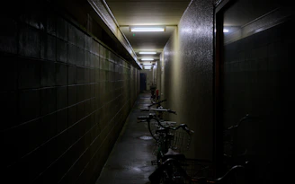 A long hallway with bikes parked on the side of it