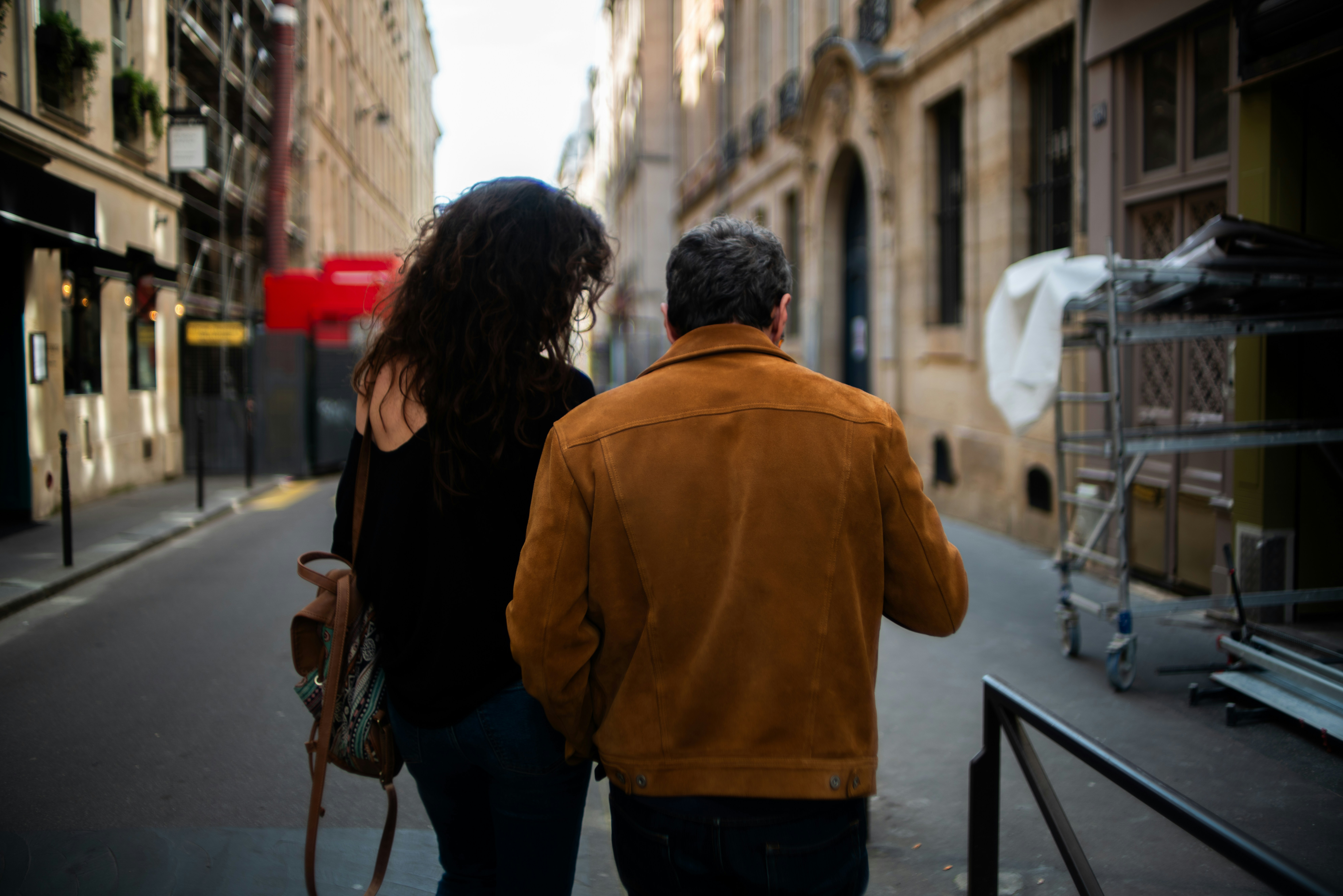 A man and a woman walking down a city street