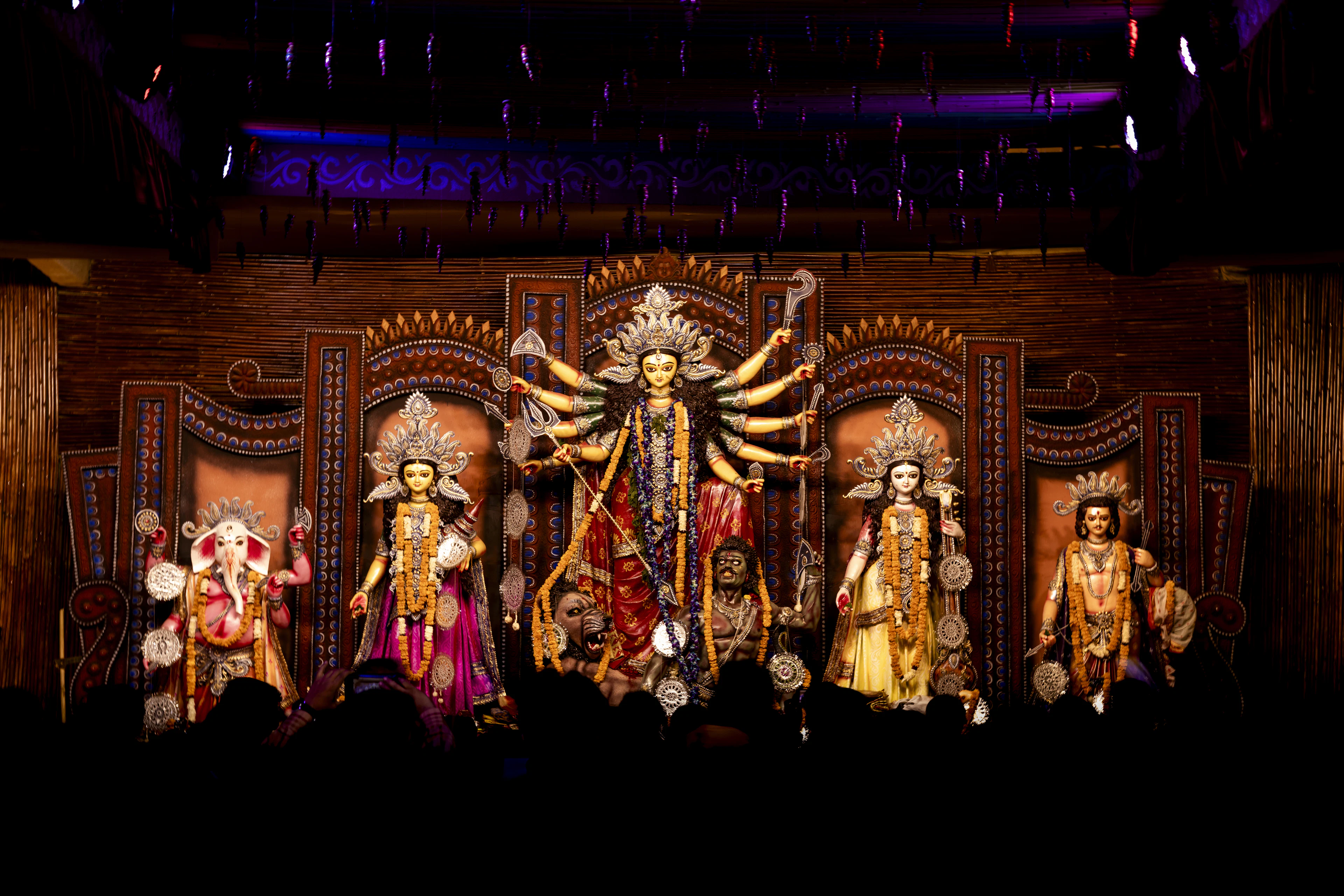 Durga Puja pandal with the goddess and her family lit up on stage