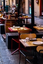 A row of tables and chairs on a sidewalk