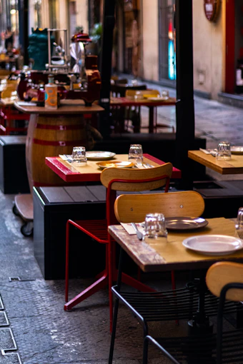 A row of tables and chairs on a sidewalk
